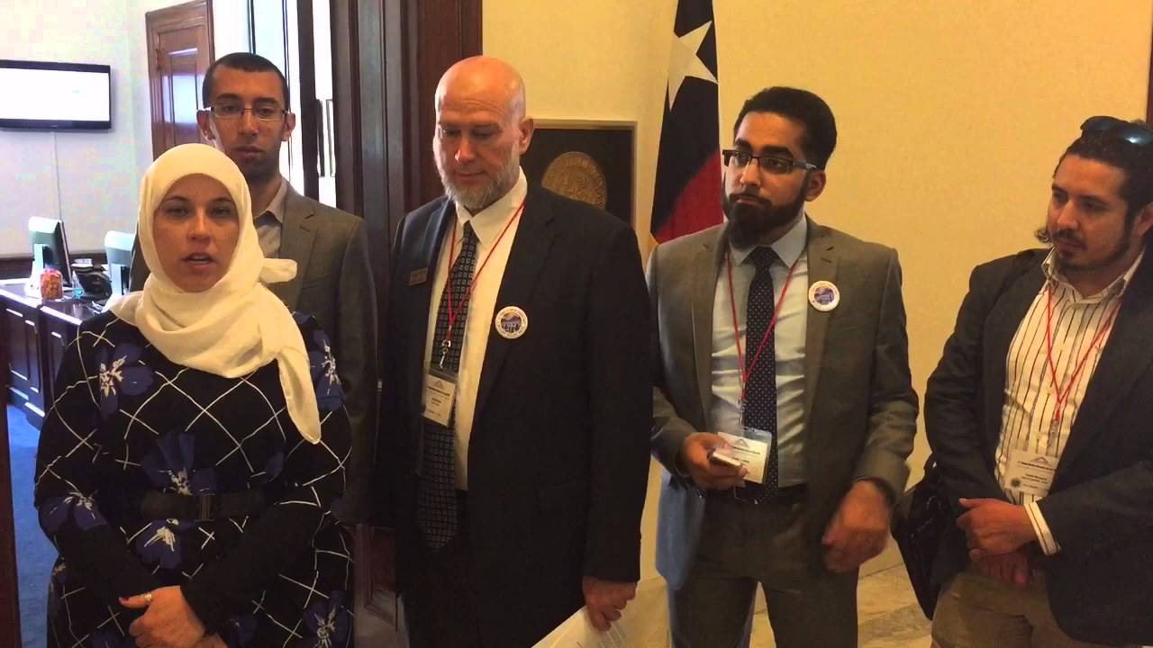 Texas constituents stand outside the office of Senator Ted Cruz. Several of the constituents pictured are visibly Muslim.
