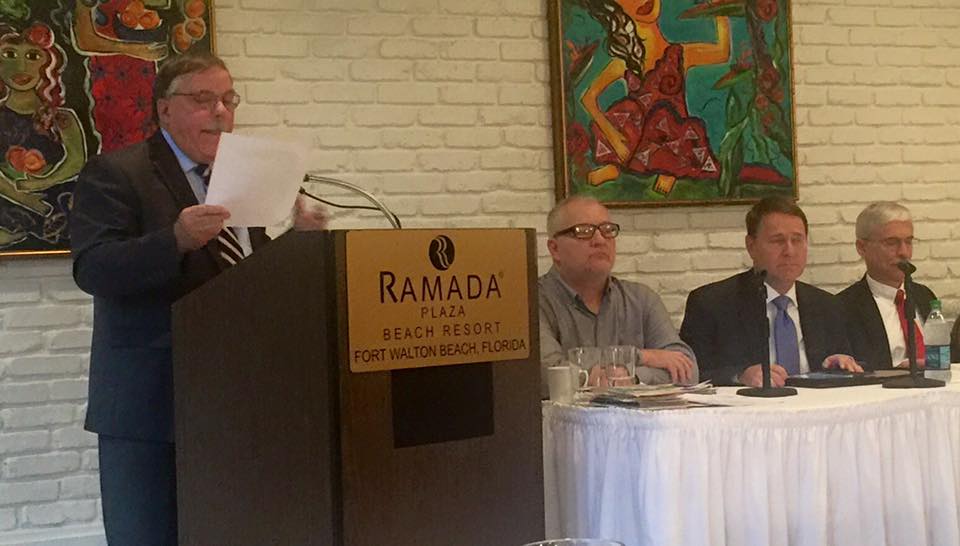 Panelists address audience members at "Understanding the Impact of Refugee Resettlement: Economically, Socially, and Culturally" in Fort Walton Beach, FL, on January 9, 2015.