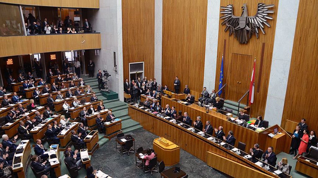 Lawmakers gather inside the Austrian parliament building.