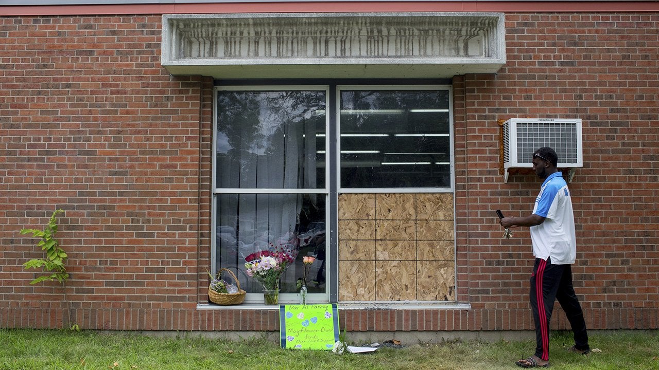 A man stands in front of a mosque that was targeted by an anti-Muslim attack.