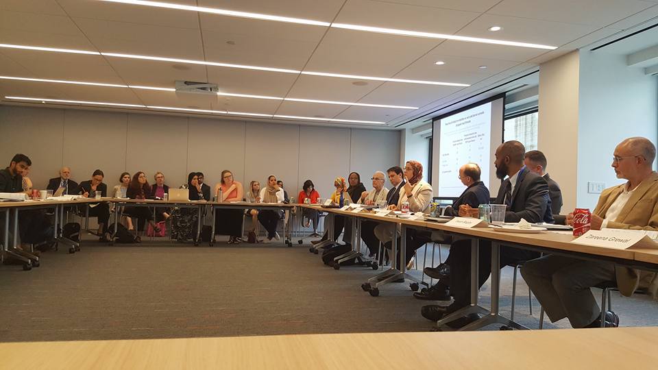 Participants sit around a table at the release of Pew Research's 2017 survey on American Muslims