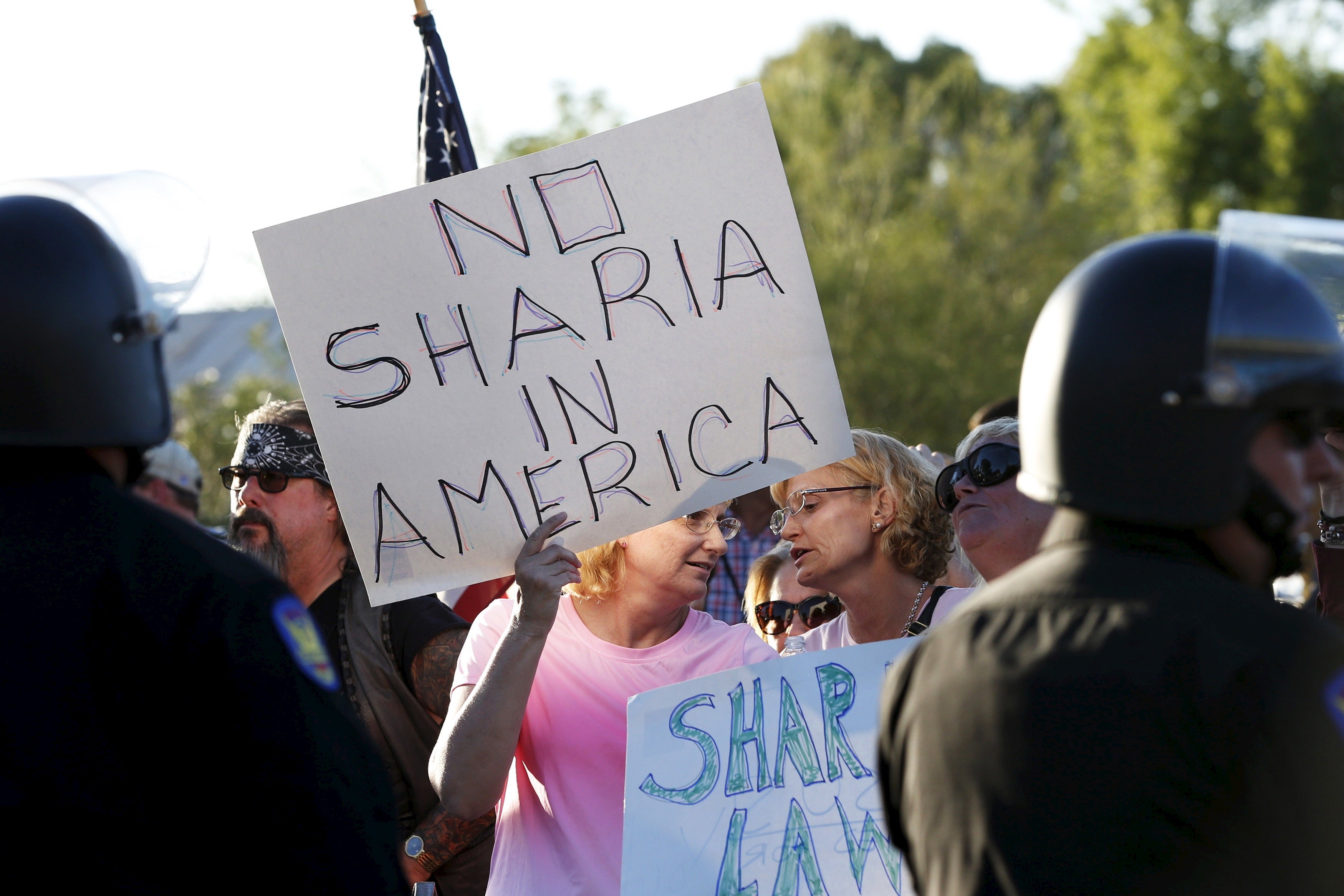 Women attend a "Freedom of Speech Rally Round II" across the street from the Islamic Community Center in Phoenix, Arizona May 29, 2015. More than 200 protesters, some armed, berated Islam and its Prophet Mohammed outside an Arizona mosque on Friday in a provocative protest that was denounced by counterprotesters shouting "Go home, Nazis," weeks after an anti-Muslim event in Texas came under attack by two gunmen.