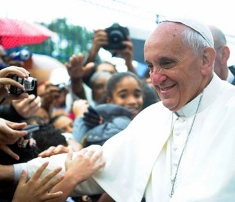 Pope Francis shakes hands with admirers during World Youth Day 2013.