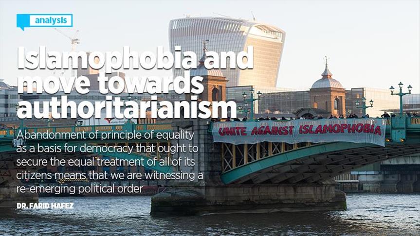 A sign that reads "Unite Against Islamophobia" hangs over the side of a bridge.