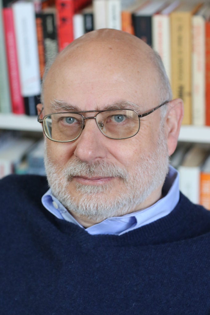 Headshot of man with glasses starting straight in to the camera