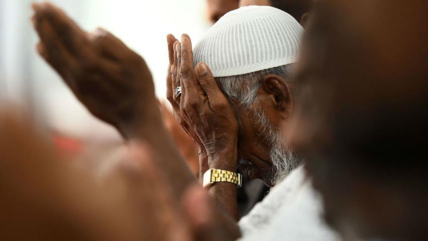 A close up shot shows an unidentified Muslim man praying