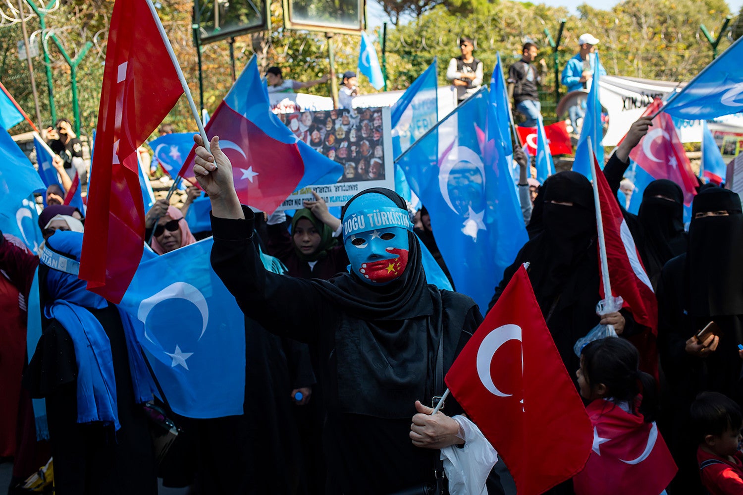 Supporters of China's Muslim Uighur minority and Turkish nationalists wave the flag of East Turkestan during an anti-China protest in front of the Chinese consulate in Istanbul on October 1, 2019, on the 70th anniversary of the founding of The People's Republic of China. (Photo by Yasin AKGUL / AFP) (Photo credit should read YASIN AKGUL/AFP via Getty Images)